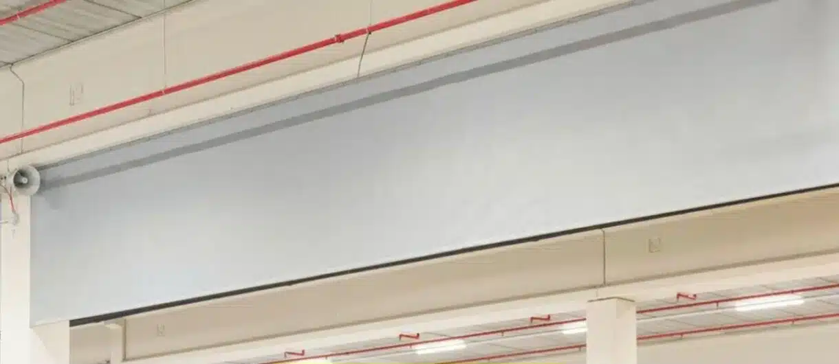 Automatic textile fire curtain system deployed in an industrial facility, showing key components and structure