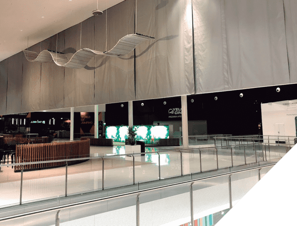 Automatic smoke curtains installed on the ceiling of a shopping mall for smoke compartmentation