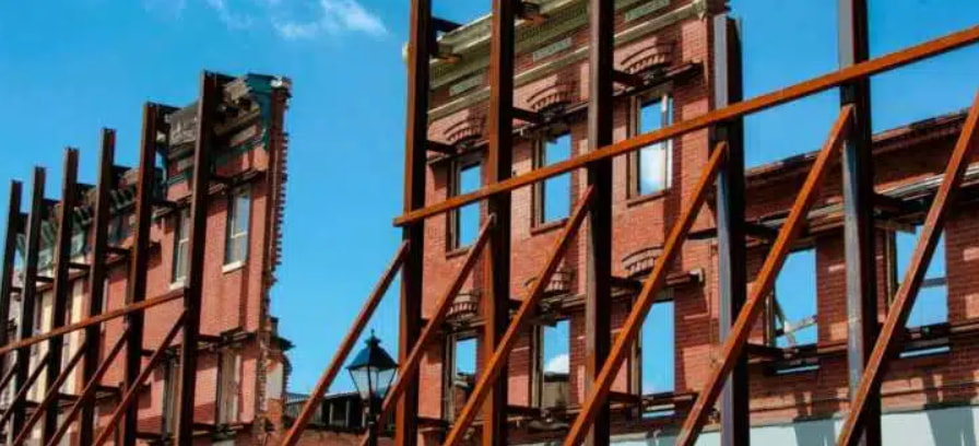 Reinforced façade of a historic building under restoration, highlighting fire safety considerations in heritage rehabilitation