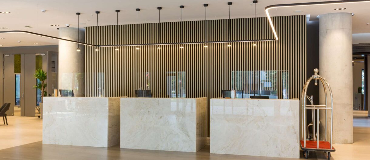 Modern hotel reception area with passive fire protection measures and strategic fire compartmentation zones