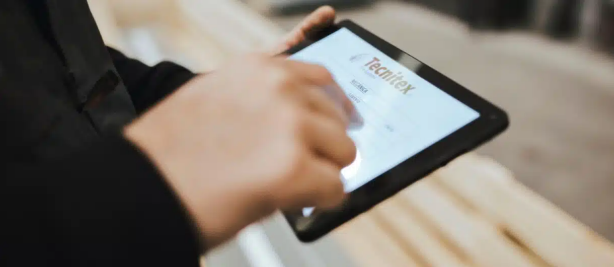 Technician using a tablet with Tecnitex software to manage passive fire protection systems